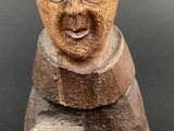 wooden figurine of a monk holding a book in his hands
