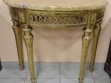 a marble top table with gold legs and a marble top