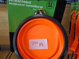 an orange frisbee hanging from a rack in a store
