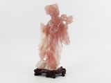 a figurine of a woman standing on a wooden base