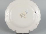 underside view of a plate showing the scalloped edge