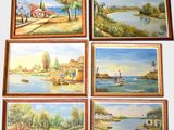 four framed paintings of a river scene with boats on the water