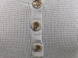 a close up of a sweater with buttons on it