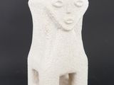 an image of a white ceramic sculpture of a bear on a black background