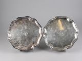 pair of silver plated trays on stand on grey background