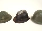 three helmets are lined up in a row on a white surface