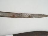 two knives that are on a table