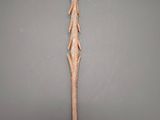 an old wooden sword with a long blade on a gray background