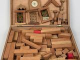 a wooden box filled with wooden blocks and a clock