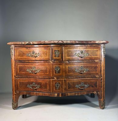 une commode ancienne avec un dessus en marbre et des poignées en laiton
