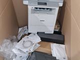 a box with a printer and other electronic items in it