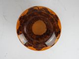 a brown and black bowl sitting on a white table