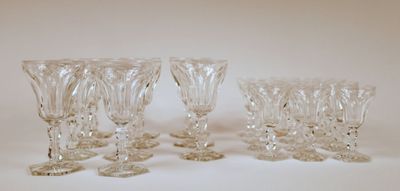 four clear glass wine glasses sitting on top of a white table