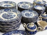 a lot of blue and white plates and cups on the table