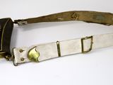 an old belt with a metal buckle on a white surface