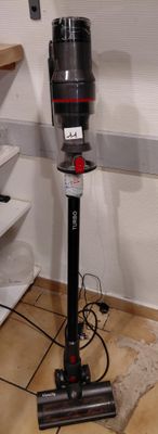 a vacuum that is sitting on the floor in the room