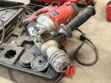 a drill and other tools on the floor in the garage