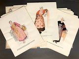 several old fashion plates of women ' s clothing on display on a table