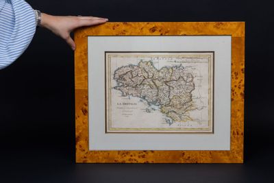 someone is holding a picture of a map in front of a black background