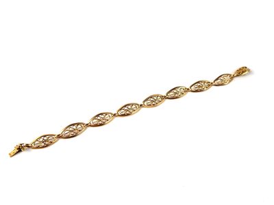 a close up of a gold bracelet on a white background