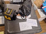 a table with a lot of items on it and a sign on it