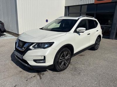 un SUV Nissan blanc garé devant un immeuble