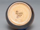 a brown and blue vase with writing on it