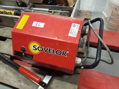 a red machine that is sitting on a pallet