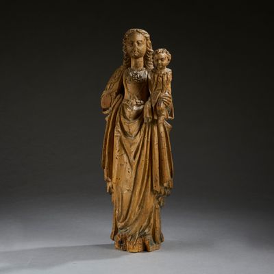 a wooden statue of a woman holding a child in her arms