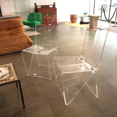 two clear stools sitting on the floor in a living room