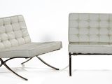 pair of white leather chairs with chrome legs against a white backdrop