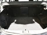 the back of a car with the trunk open and the seat folded down