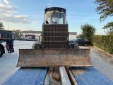 a bulldozer that is sitting in the middle of a parking lot