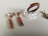 three pieces of jewelry sitting on top of a table next to each other