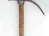 a close up of a hammer on a white surface