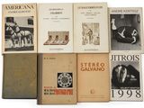 several books are stacked on top of each other on a white surface