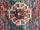 a close up of a rug with a red, white and blue design