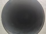 a black vase sitting on top of a white table
