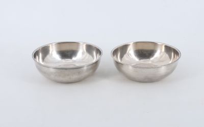 a pair of silver plated bowls on a white background