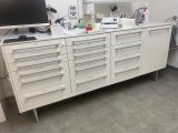 a white cabinet with drawers and a computer on it