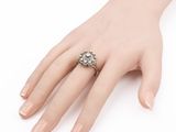 a close up of a person ' s hand with a ring on it