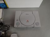 a sony game system sitting on a table next to a remote