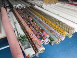 many rolls of fabric on the floor next to each other
