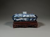 chinese blue and white porcelain box on wooden stand on grey background