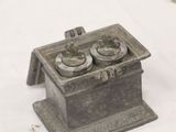 a small metal box that has two cups in it