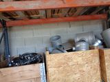 a pile of metal pipes and other items in a room