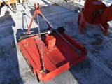 a red tractor with chains attached to the back of it