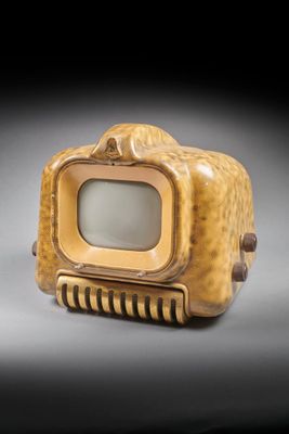 a small television sitting on top of a wooden box