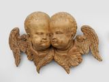 pair of carved cherenshes with wings on a white background