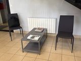 two black chairs and a coffee table in a living room